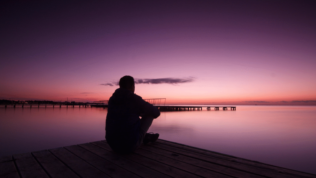 Person Writing in a Journal at Sunrise